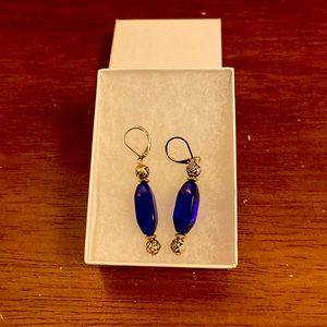 Silver tone dangle rose earrings with blue stone